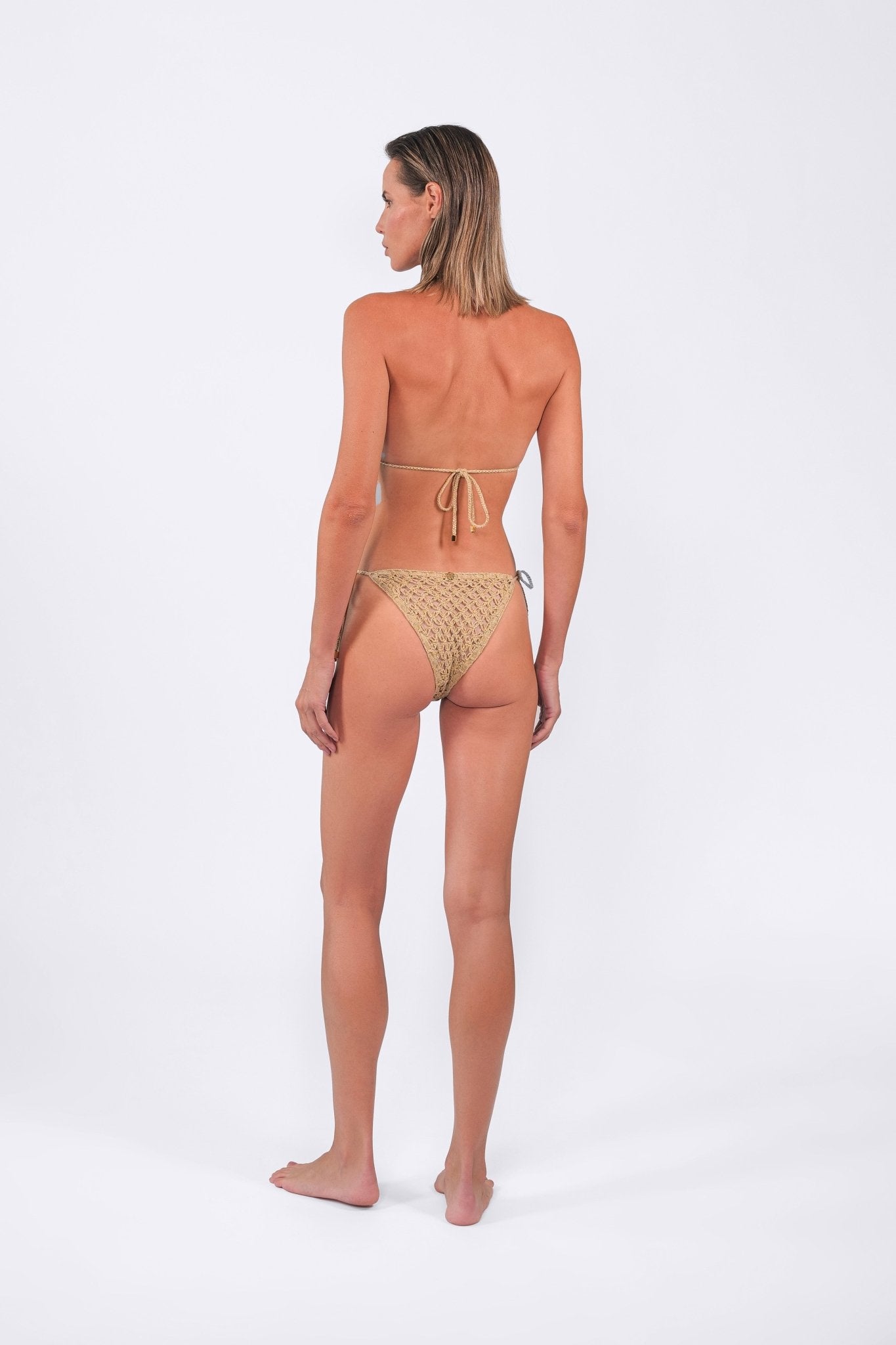 Back view of the model wearing The Hidden Secret Crochet Bikini Set in Beige. 